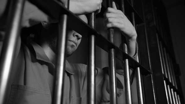 prisoner behind bars