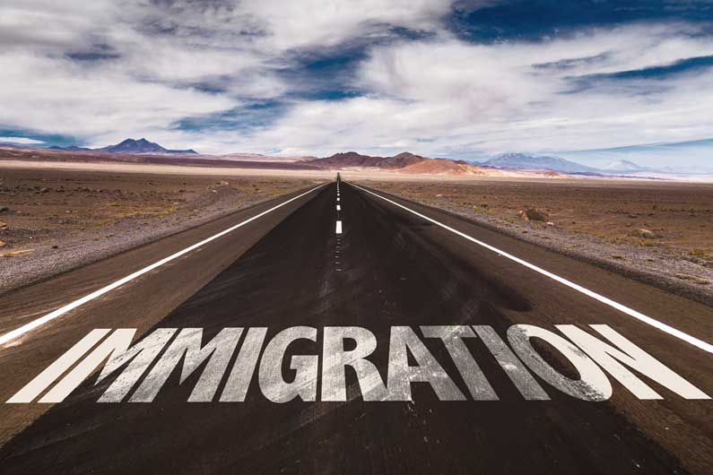 immigration written on road in desert