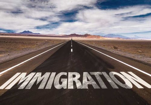 immigration written on road in desert